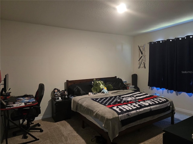 bedroom with baseboards and carpet
