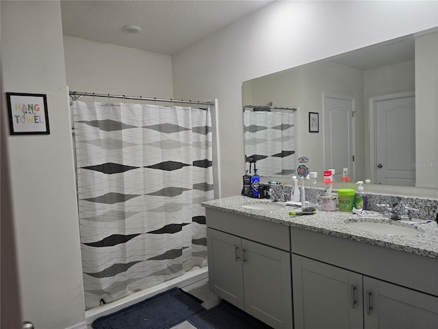 full bath featuring a sink, double vanity, and a shower with shower curtain