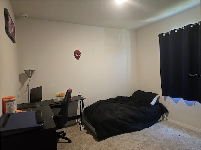 bedroom with baseboards and carpet