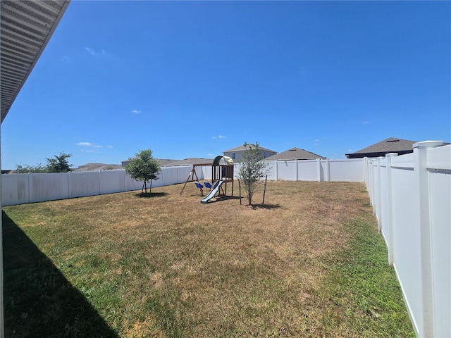 view of yard featuring a fenced backyard and a playground