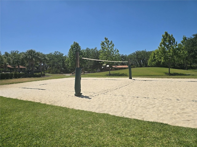 view of home's community with a yard and volleyball court
