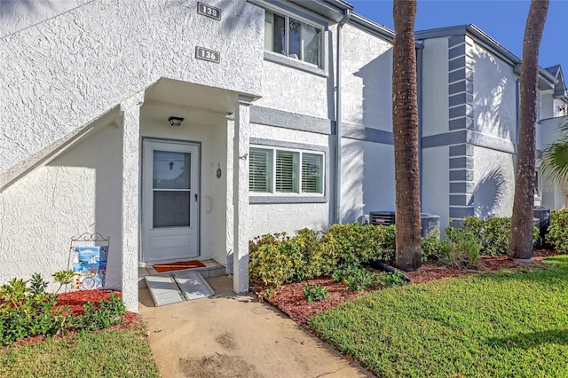 136 Beach Park Ln Unit 35, Cape Canaveral, FL 32920 - view of exterior entry with stucco siding