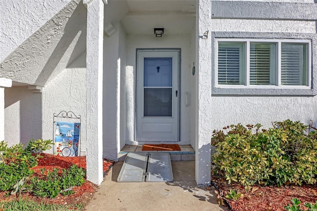 136 Beach Park Ln Unit 35, Cape Canaveral, FL 32920 - view of exterior entry featuring stucco siding