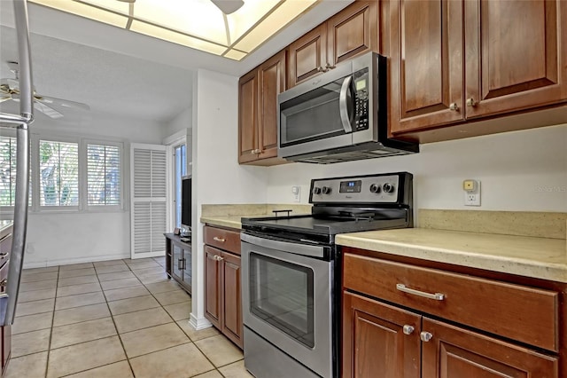 136 Beach Park Ln Unit 35, Cape Canaveral, FL 32920 - kitchen featuring appliances with stainless steel finishes, a ceiling fan, light countertops, and light tile patterned floors