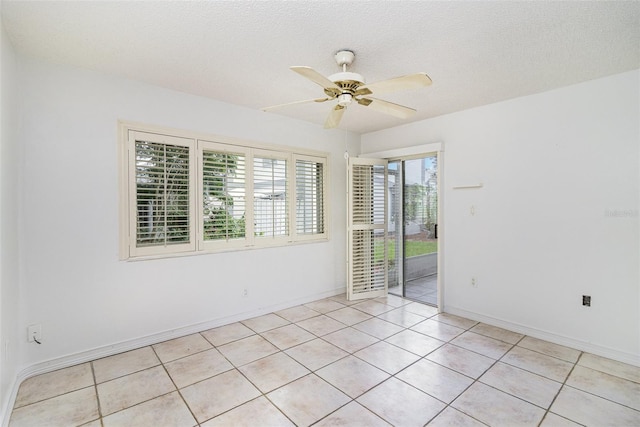 136 Beach Park Ln Unit 35, Cape Canaveral, FL 32920 - unfurnished room featuring a ceiling fan, light tile patterned flooring, baseboards, and a textured ceiling