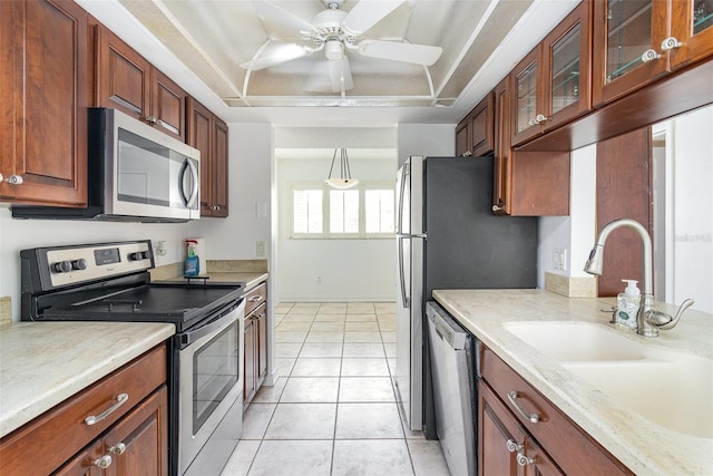 136 Beach Park Ln Unit 35, Cape Canaveral, FL 32920 - kitchen with appliances with stainless steel finishes, light tile patterned floors, a sink, ceiling fan, and glass insert cabinets