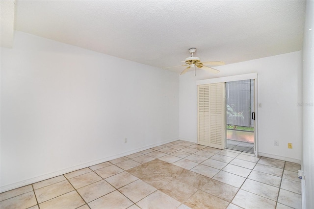 136 Beach Park Ln Unit 35, Cape Canaveral, FL 32920 - empty room with a ceiling fan, light tile patterned flooring, and baseboards