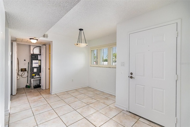 136 Beach Park Ln Unit 35, Cape Canaveral, FL 32920 - entryway with light tile patterned flooring, a textured ceiling, and baseboards