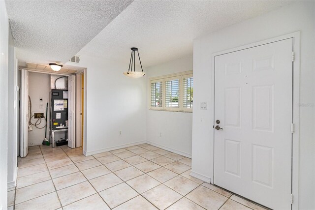 136 Beach Park Ln Unit 35, Cape Canaveral, FL 32920 - entryway with light tile patterned flooring, a textured ceiling, and baseboards