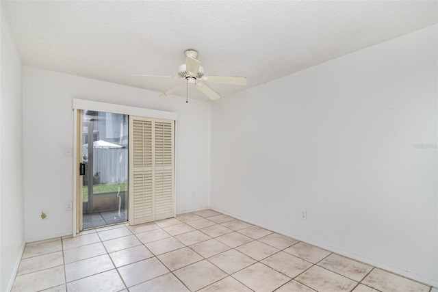 136 Beach Park Ln Unit 35, Cape Canaveral, FL 32920 - empty room featuring light tile patterned floors, baseboards, and ceiling fan