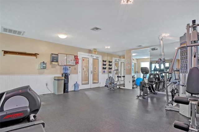 136 Beach Park Ln Unit 35, Cape Canaveral, FL 32920 - workout area featuring wainscoting and french doors