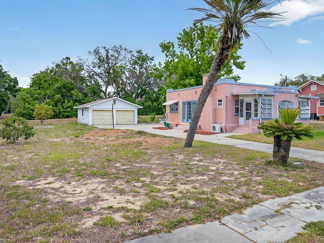16 E Orange St, Davenport, FL 33837 - view of yard with a detached garage, an outdoor structure, and entry steps