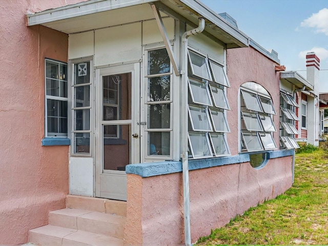 16 E Orange St, Davenport, FL 33837 - entrance to property featuring stucco siding