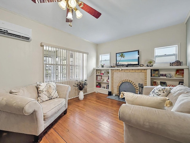16 E Orange St, Davenport, FL 33837 - living area featuring a healthy amount of sunlight, a ceiling fan, an AC wall unit, and a fireplace with flush hearth