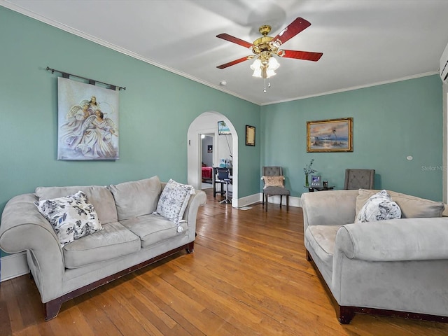 16 E Orange St, Davenport, FL 33837 - living area featuring ceiling fan, crown molding, arched walkways, hardwood / wood-style flooring, and baseboards