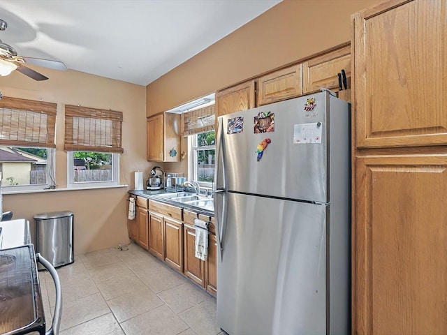 16 E Orange St, Davenport, FL 33837 - kitchen with freestanding refrigerator, a sink, ceiling fan, and light tile patterned floors
