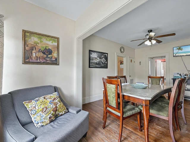 16 E Orange St, Davenport, FL 33837 - dining area featuring baseboards, ceiling fan, and wood finished floors