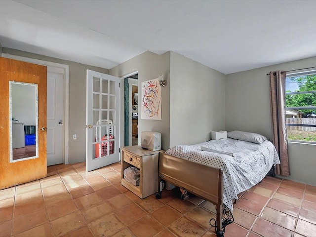 16 E Orange St, Davenport, FL 33837 - bedroom featuring french doors and light tile patterned floors