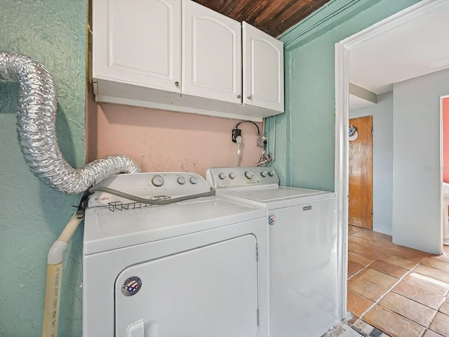 16 E Orange St, Davenport, FL 33837 - laundry room with wooden ceiling, light tile patterned flooring, cabinet space, and washing machine and clothes dryer