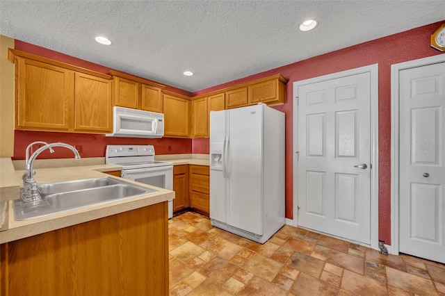 5102 Monticello Heights Ln, Oviedo, FL 32765 - kitchen with white appliances, a sink, light countertops, a textured ceiling, and brown cabinetry