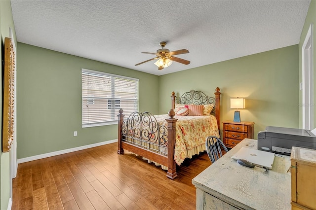 5102 Monticello Heights Ln, Oviedo, FL 32765 - bedroom with baseboards, wood finished floors, a ceiling fan, and a textured ceiling