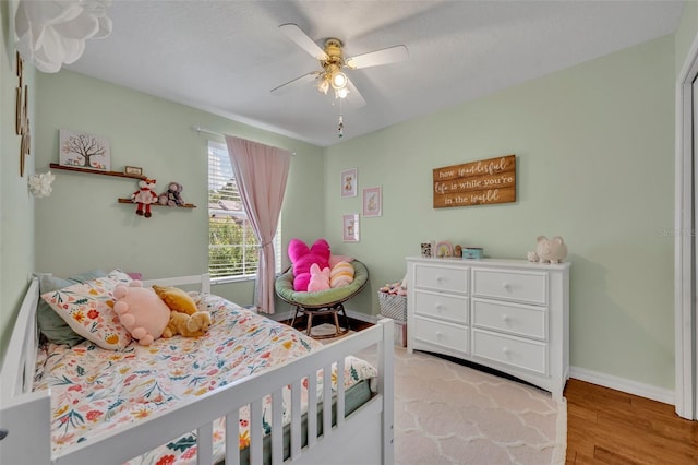 5102 Monticello Heights Ln, Oviedo, FL 32765 - bedroom with light wood-style flooring, baseboards, and a ceiling fan