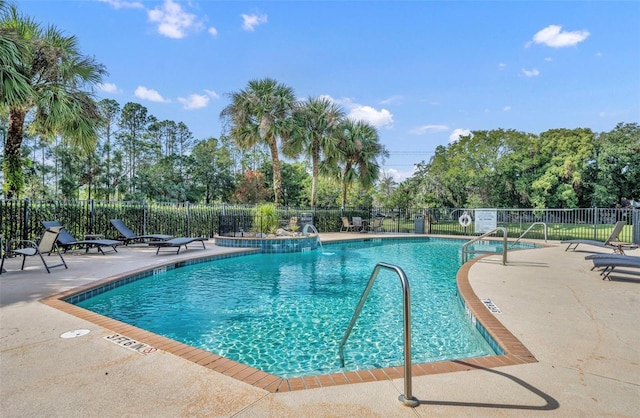 5102 Monticello Heights Ln, Oviedo, FL 32765 - community pool featuring a patio and view of wooded area