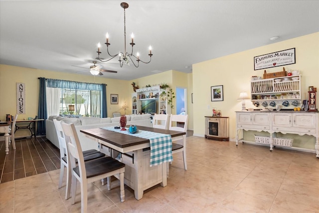 dining room with light tile patterned floors and ceiling fan with notable chandelier