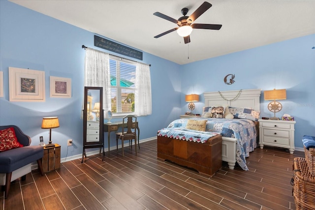 bedroom with a ceiling fan, baseboards, and wood finished floors