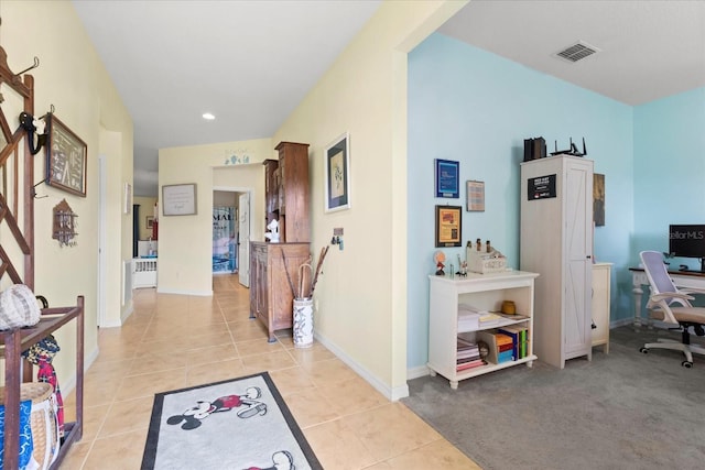hallway featuring visible vents, recessed lighting, baseboards, and light tile patterned floors