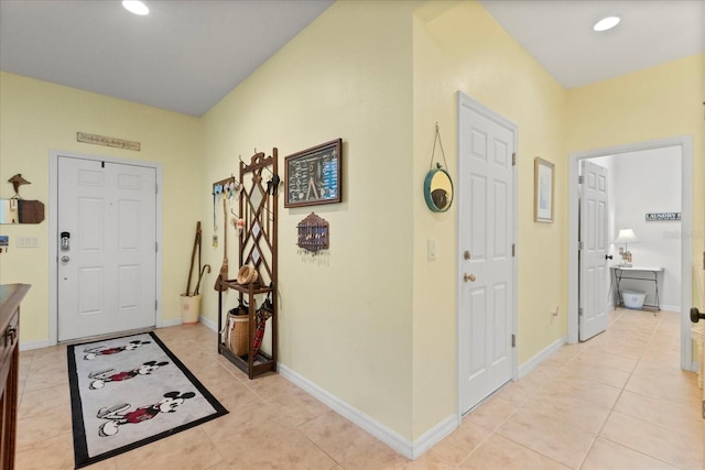entrance foyer featuring recessed lighting, baseboards, and light tile patterned floors