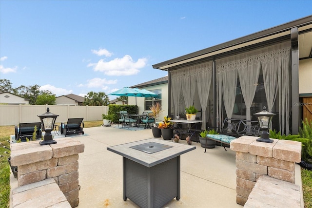 view of patio featuring outdoor dining area and fence