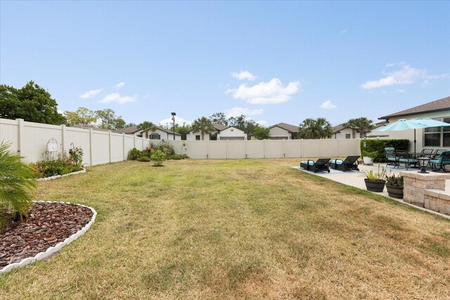 view of yard with a fenced backyard and a patio area