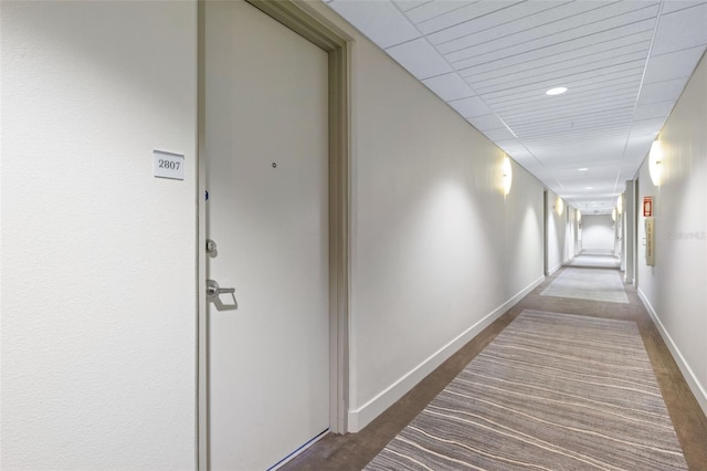 corridor featuring baseboards and recessed lighting