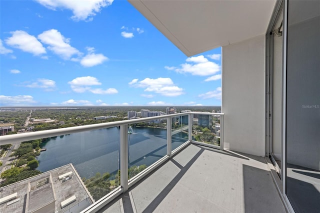 balcony featuring a view of city and a water view