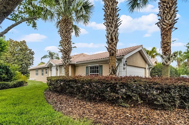 11908 Delfina Ln, Orlando, FL 32827 - view of front of house with a front lawn, stucco siding, an attached garage, and a tile roof
