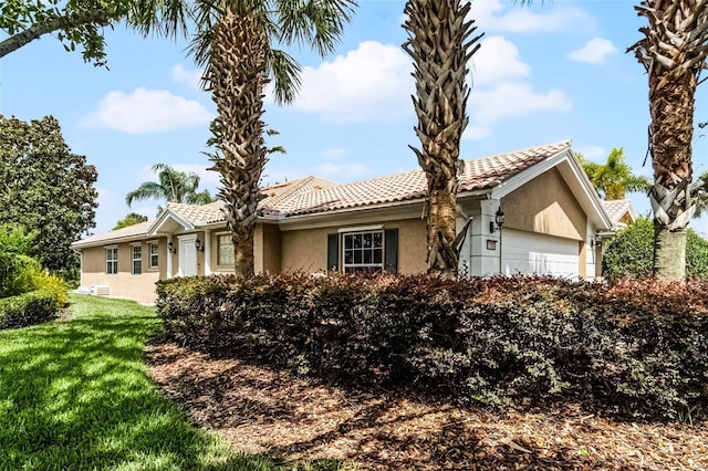 11908 Delfina Ln, Orlando, FL 32827 - single story home with a front lawn, a tiled roof, stucco siding, and a garage