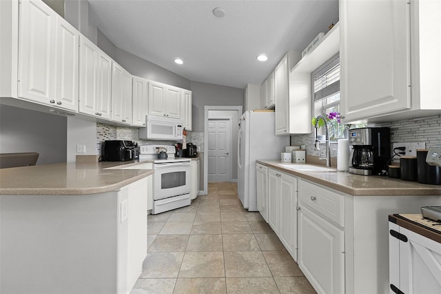 11908 Delfina Ln, Orlando, FL 32827 - kitchen with a sink, white appliances, recessed lighting, decorative backsplash, and white cabinets