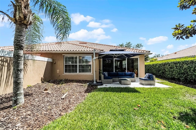 11908 Delfina Ln, Orlando, FL 32827 - rear view of property featuring an outdoor living space, a lawn, a patio area, stucco siding, and a tile roof