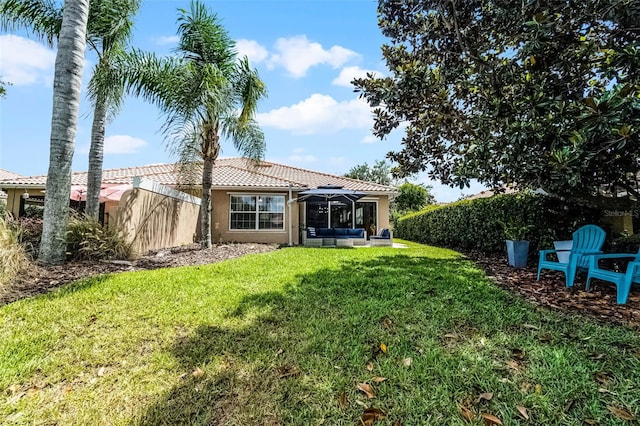 11908 Delfina Ln, Orlando, FL 32827 - rear view of property featuring a yard, stucco siding, a tile roof, and fence