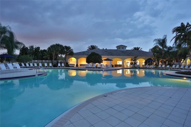 11908 Delfina Ln, Orlando, FL 32827 - pool at dusk with fence and a community pool