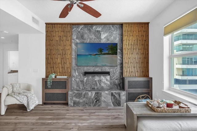 1238 E Kennedy Blvd Unit 802, Tampa, FL 33602 - living room featuring visible vents, a ceiling fan, wood finished floors, and a fireplace