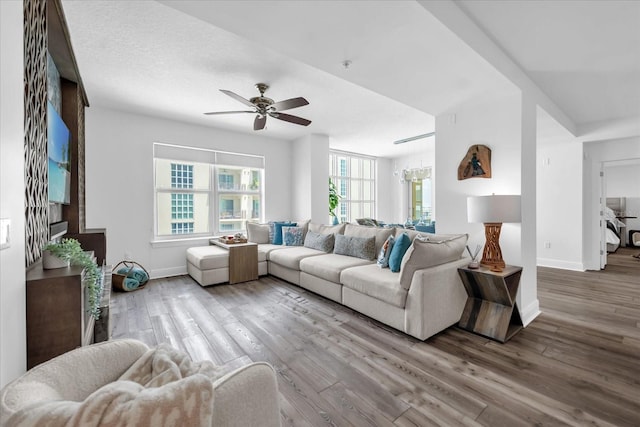 1238 E Kennedy Blvd Unit 802, Tampa, FL 33602 - living room featuring baseboards, a ceiling fan, and a healthy amount of sunlight