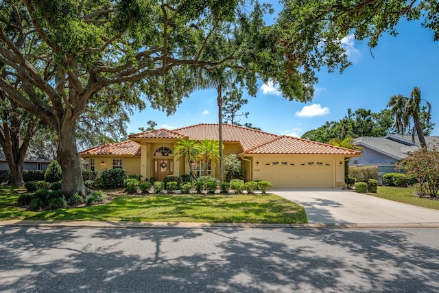 8202 Shadow Pine Way, Sarasota, FL 34238 - mediterranean / spanish home featuring a garage, a tiled roof, concrete driveway, and stucco siding