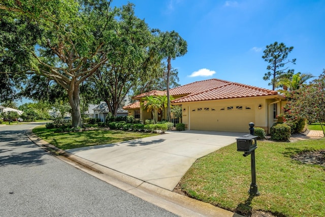 8202 Shadow Pine Way, Sarasota, FL 34238 - mediterranean / spanish-style house with stucco siding, an attached garage, a tiled roof, concrete driveway, and a front yard