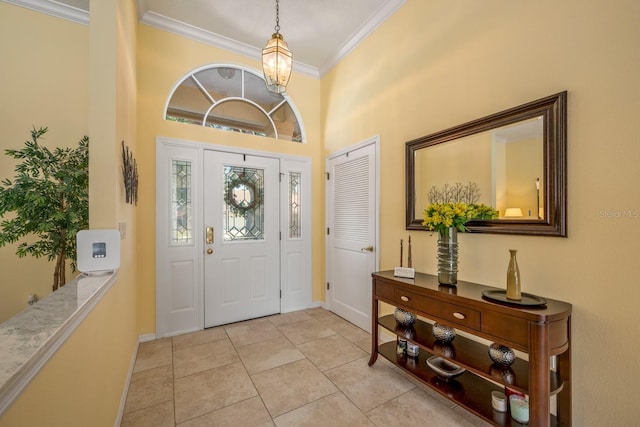 8202 Shadow Pine Way, Sarasota, FL 34238 - foyer featuring crown molding, baseboards, light tile patterned floors, a towering ceiling, and a chandelier