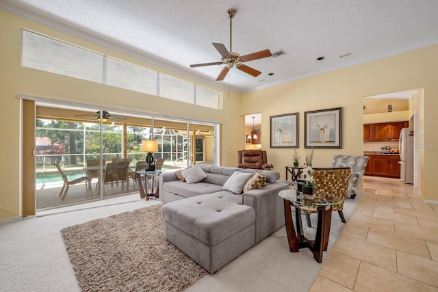 8202 Shadow Pine Way, Sarasota, FL 34238 - living room with a ceiling fan, crown molding, a sunroom, a towering ceiling, and light tile patterned flooring