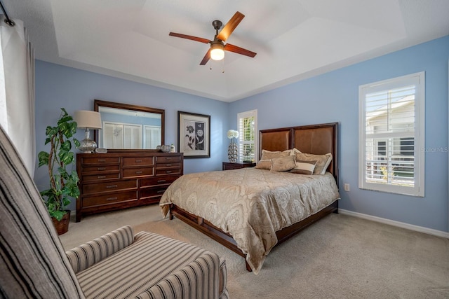 8202 Shadow Pine Way, Sarasota, FL 34238 - carpeted bedroom featuring a raised ceiling, baseboards, and ceiling fan