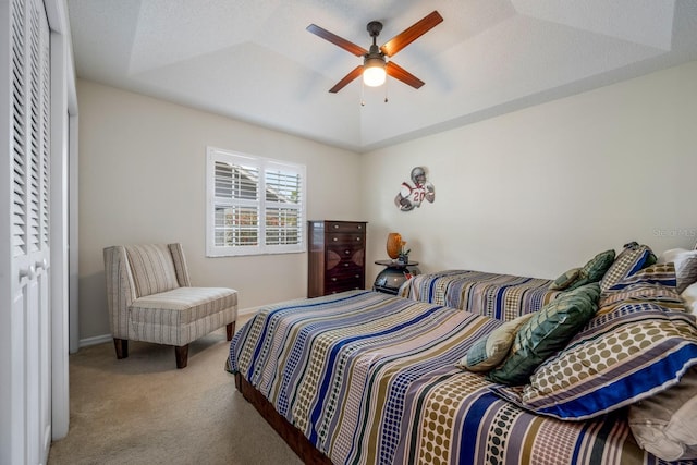 8202 Shadow Pine Way, Sarasota, FL 34238 - carpeted bedroom featuring baseboards, a raised ceiling, and a ceiling fan