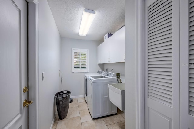8202 Shadow Pine Way, Sarasota, FL 34238 - laundry room featuring cabinet space, separate washer and dryer, a textured ceiling, baseboards, and light tile patterned floors